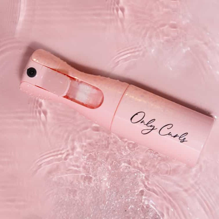 Only Curls Misting Bottle lying flat in water - Only Curls