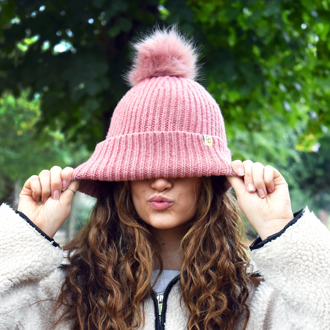 Woman with defined curls wearing an Only Curls satin-lined winter beanie