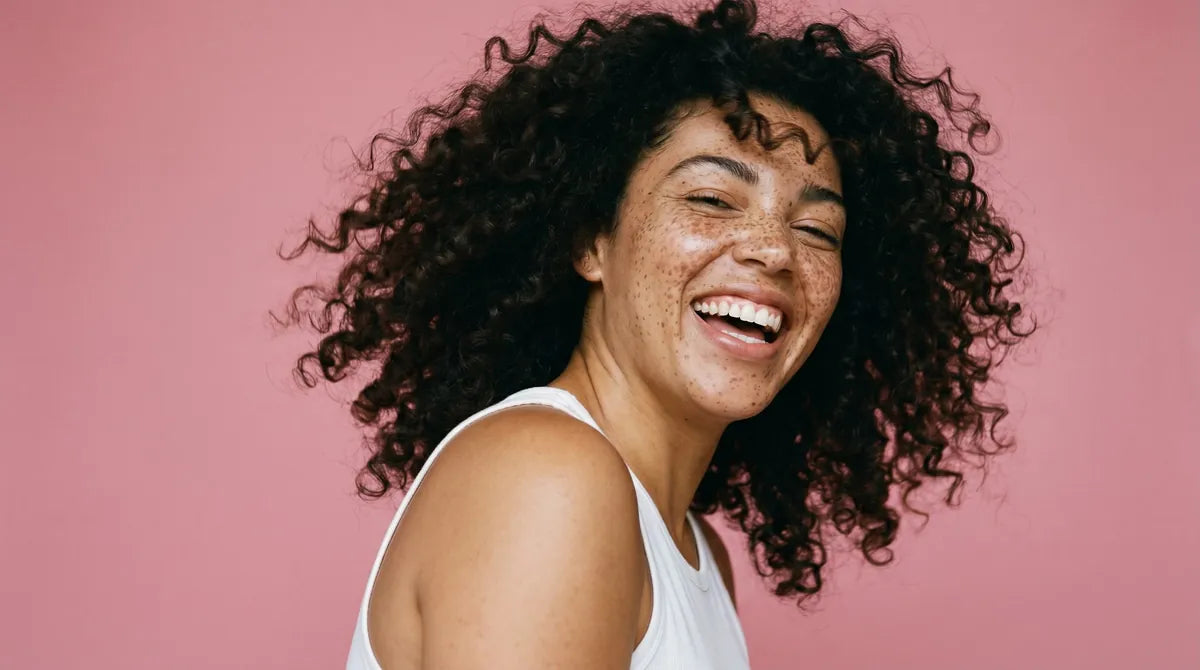 Smiling woman with voluminous natural curls
